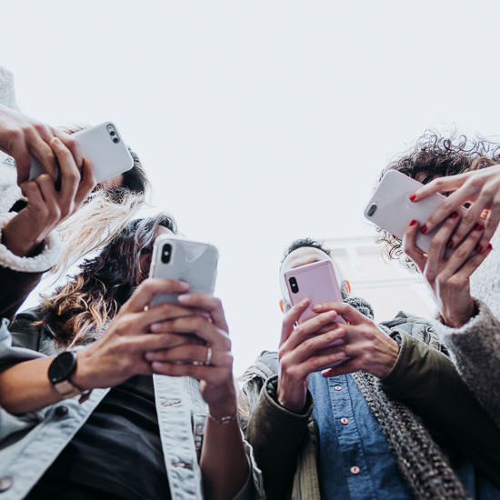 Group of friends in the street with smartphone