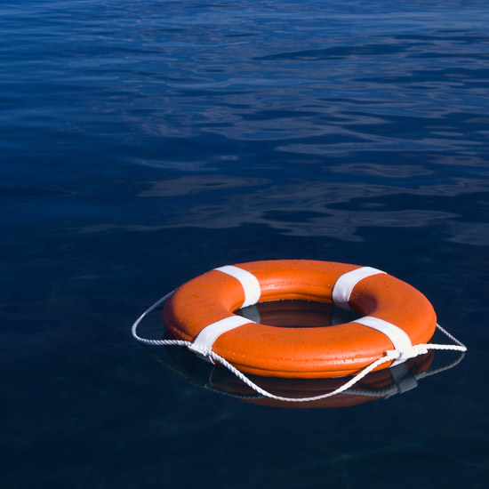 Round life preserver floating in water