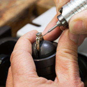 A Jeweller is Repairing a Diamond Ring.